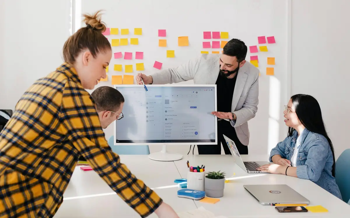 Marketing team planning a digital campaign around a strategy board